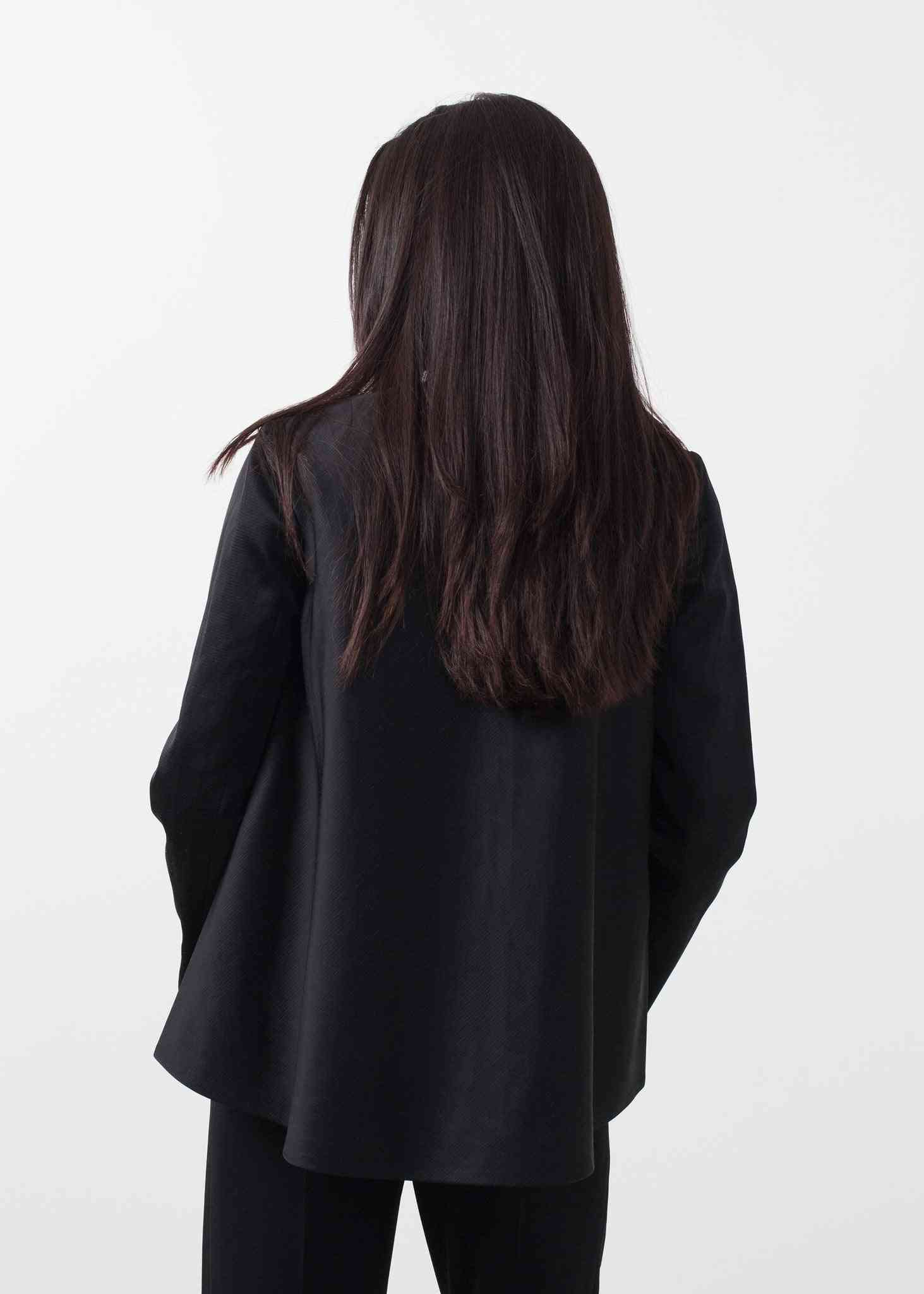 the back of a woman wearing a black jacket
